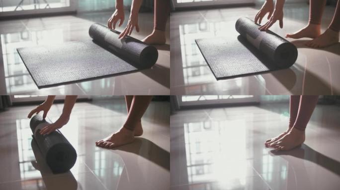 女人推出瑜伽垫并准备冥想瑜伽训练