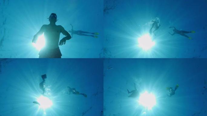 女士夫妇在克罗地亚阳光明媚的亚得里亚海水下浮潜