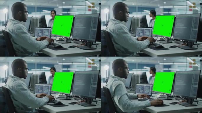多民族办公室: 黑色IT程序员在电脑上工作，绿屏色度键显示。男软件工程师开发应用程序，程序，视频游戏