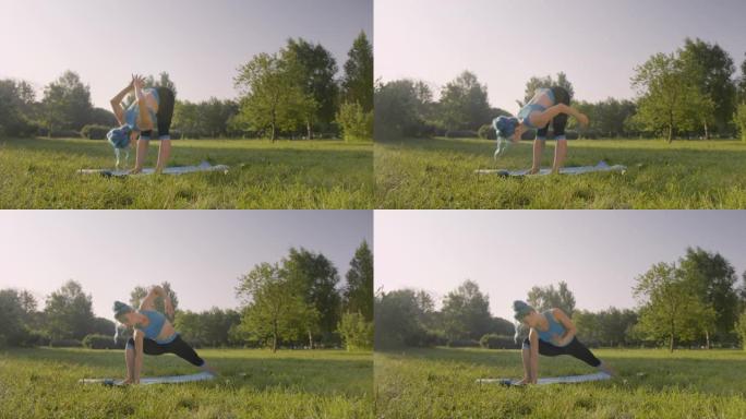 一个夏天的早晨，一位迷人的瑜伽老师正在公园的瑜伽垫上练习