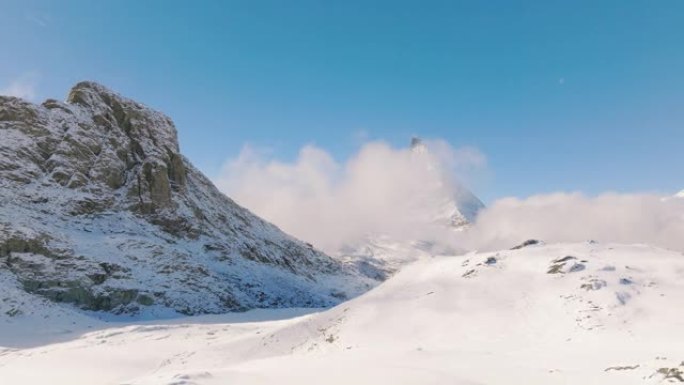 站在瑞士马特宏峰山顶的旅行者年轻女性的空中无人机视图。大自然中的幸福。具有多样性概念的体验式旅行。与