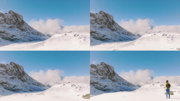 站在瑞士马特宏峰山顶的旅行者年轻女性的空中无人机视图。大自然中的幸福。具有多样性概念的体验式旅行。与