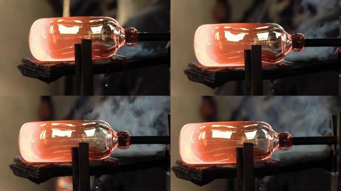 玻璃制造商工匠将熔融玻璃塑造成精细的水晶产品，手工吹制玻璃的艺术。特写。4k分辨率。