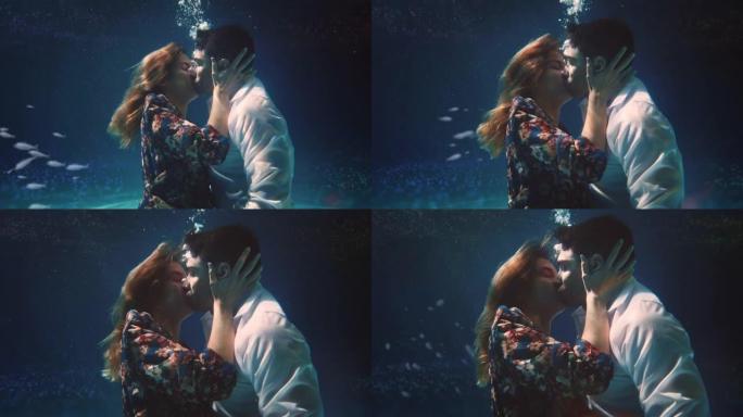 年轻无忧无虑的浪漫情侣在蜜月假期期间在水下的海洋中激情接吻的电影镜头。爱情、关系、自由、性感、幻想的