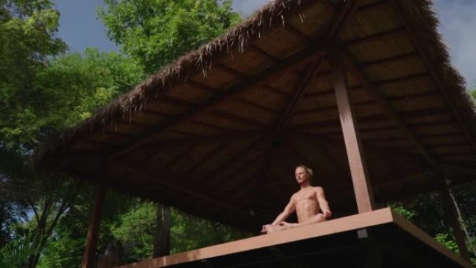 Man meditating in an open space yoga studio