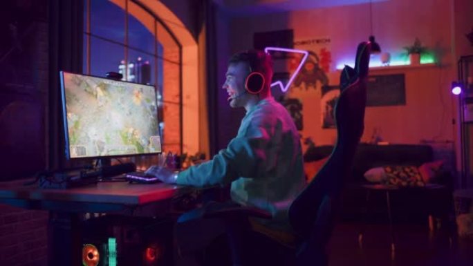 专业电子竞技游戏玩家在阁楼公寓的家里用他强大的个人电脑玩RPG策略视频游戏，有很多动作和乐趣。成功的