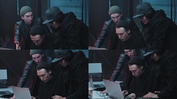 黑客在黑暗办公室的笔记本电脑上编码