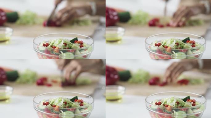 4k视频片段，一个无法识别的女人在家中制作健康的沙拉