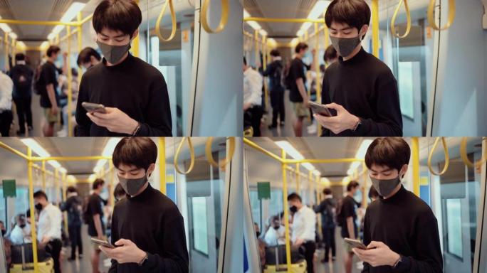 亚洲乘客在火车上使用智能手机并戴上防护口罩