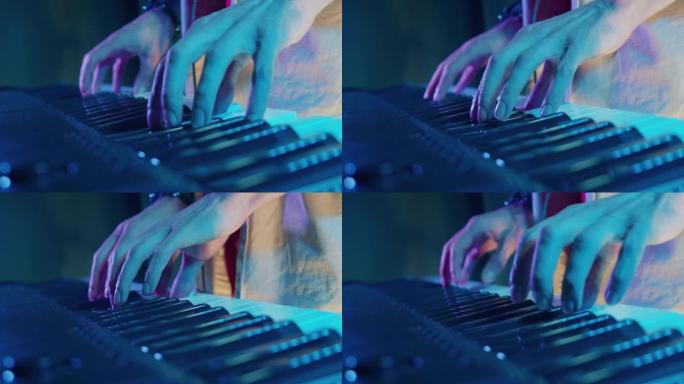 音乐家在钢琴上弹奏的手的特写