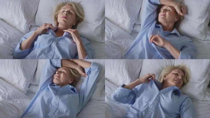 患有失眠的更年期成熟妇女在家中躺在床上醒来-慢动作射击