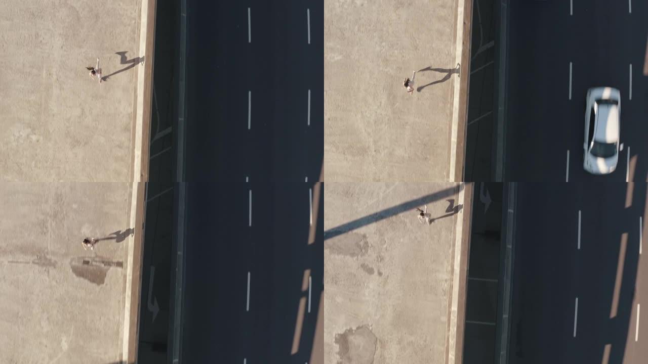 4k视频片段，一名年轻女子在城市的一座桥上奔跑