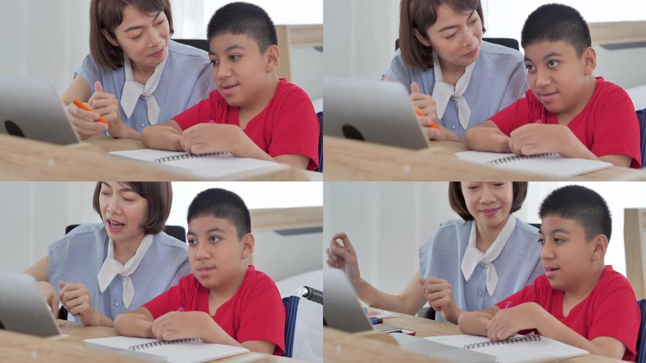 亚洲残疾男孩与亚洲年轻女性交谈照顾者在家通过电脑帮助家庭教育。残疾收集2019