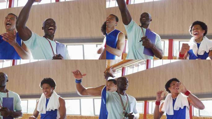 多元化的男子篮球队和教练一起庆祝，微笑和击掌