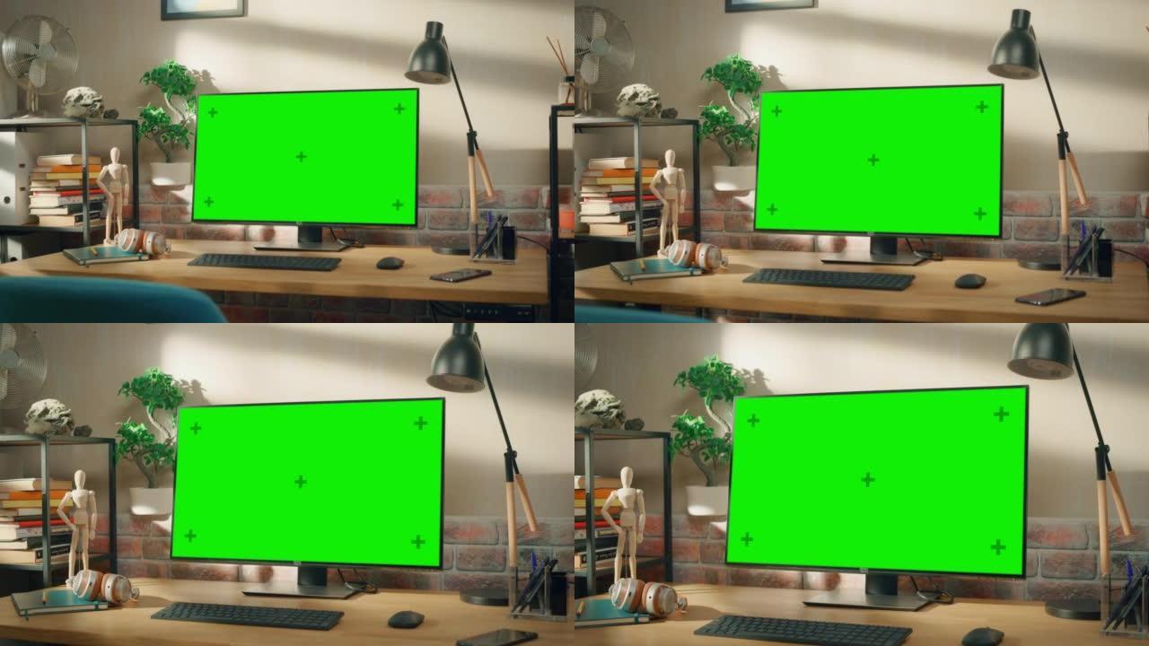 台式计算机显示器站在桌子上，带有绿屏Chromakey模拟显示器。舒适的空阁楼公寓，桌子上有一盏灯、