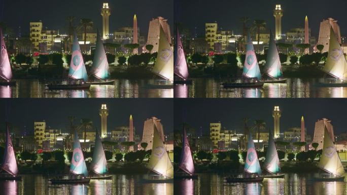 埃及卢克索之夜。游艇在城市的背景下在尼罗河上航行。缩小镜头