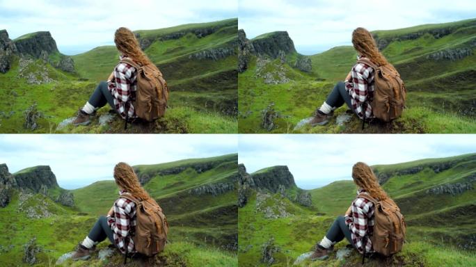 4k视频片段，一名妇女在山上徒步旅行时休息
