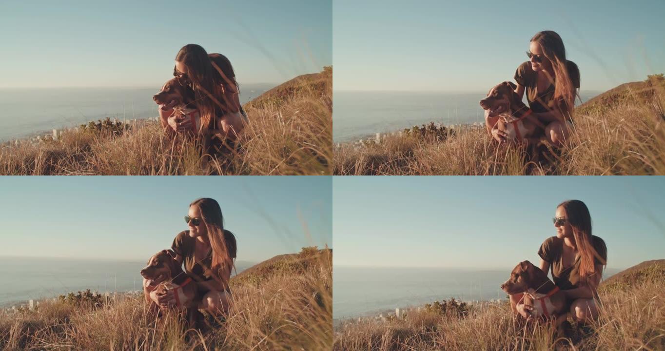 4k视频片段，一位迷人的年轻女子白天与她的狗一起徒步旅行