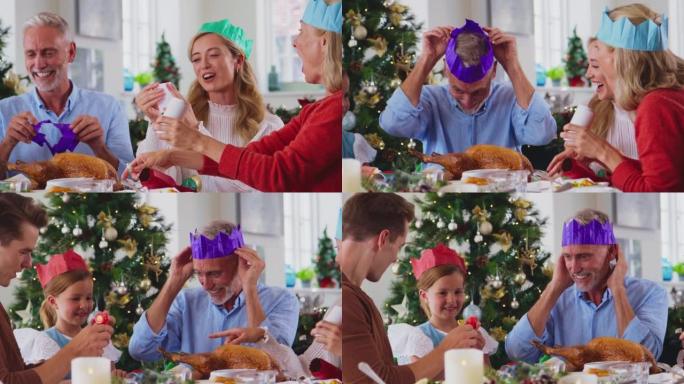 多代家庭在饭前戴着饼干上的纸帽在家庆祝圣诞节