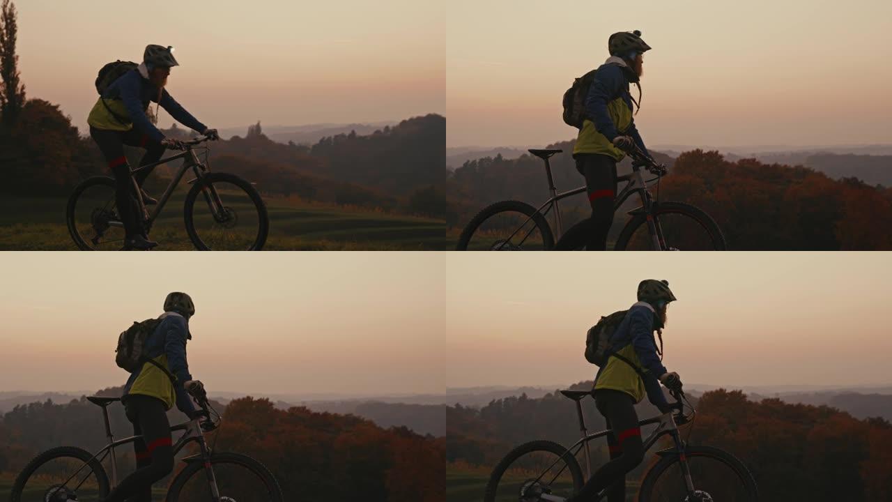 SLO MO Mountain骑自行车的人在黄昏时在乡下骑自行车时停下来休息一下