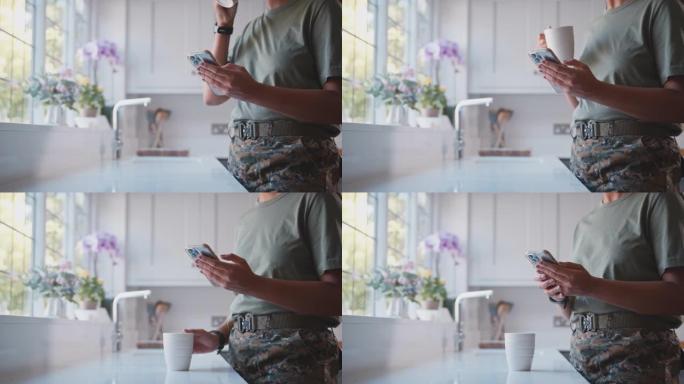在厨房里用手机拍摄的美军女兵的近景——慢镜头
