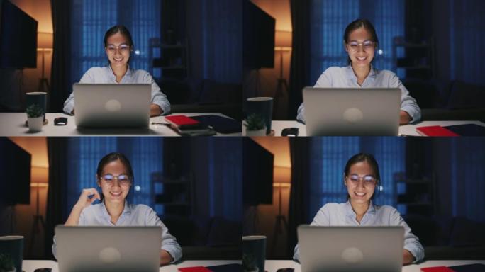 年轻的女商人晚上在现代家庭办公室使用笔记本电脑