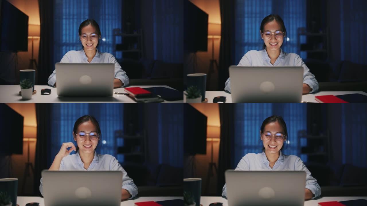 年轻的女商人晚上在现代家庭办公室使用笔记本电脑