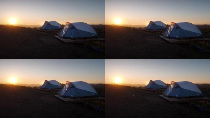 日落时大自然中的露营帐篷