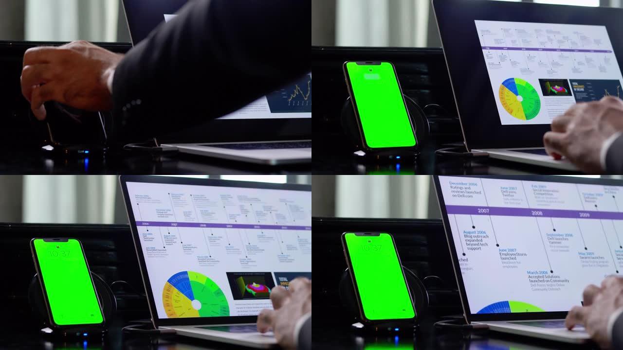 商人的近距离人手坐在桌子上使用labtop计算机处理销售报告，远程工作和社交隔离，而手机显示充电状态