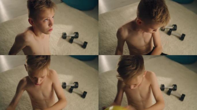 足球比赛前，专注的男孩在他的房间里裸上身练习