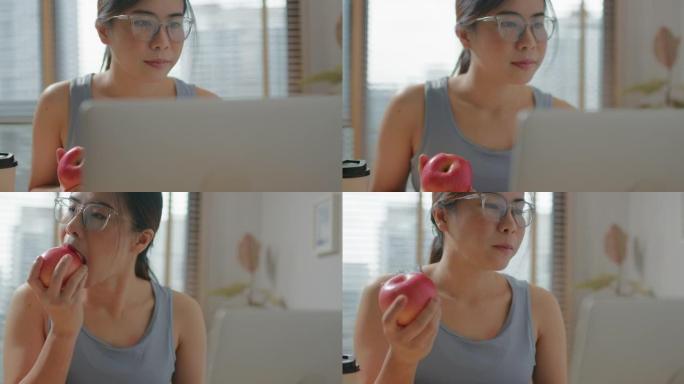 在家锻炼后吃苹果的幸福女人