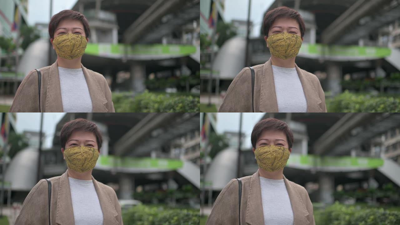 亚洲华人妇女戴着防护口罩走在城市的桥上，在市中心上班