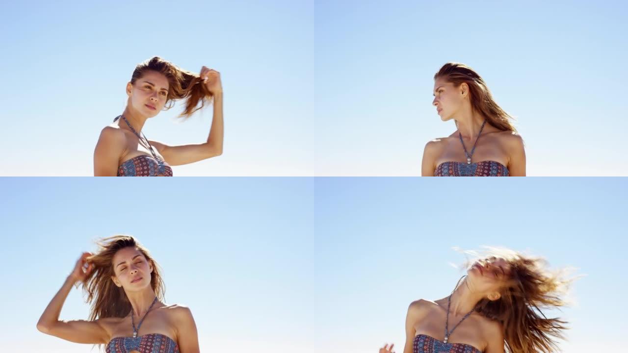 一个美丽的女人在海滩上解开头发的4k视频片段