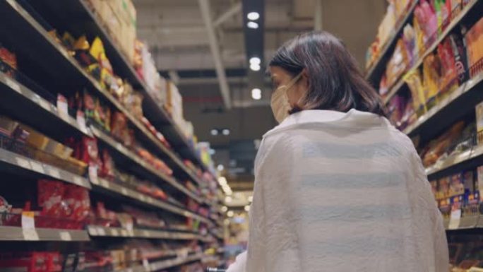 Asian woman shopping for groceries at supermarket