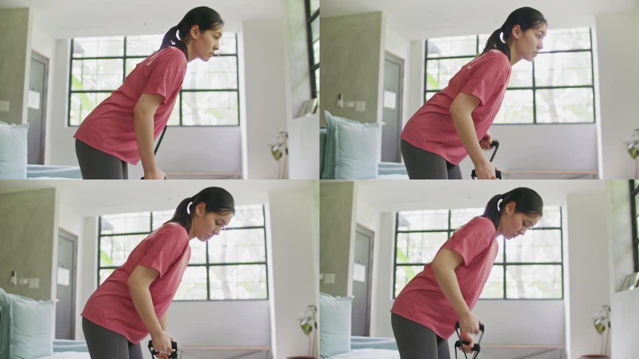 亚洲运动女子在家用阻力带锻炼
