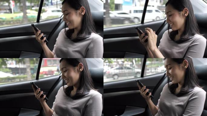 亚洲女性在汽车上使用智能手机