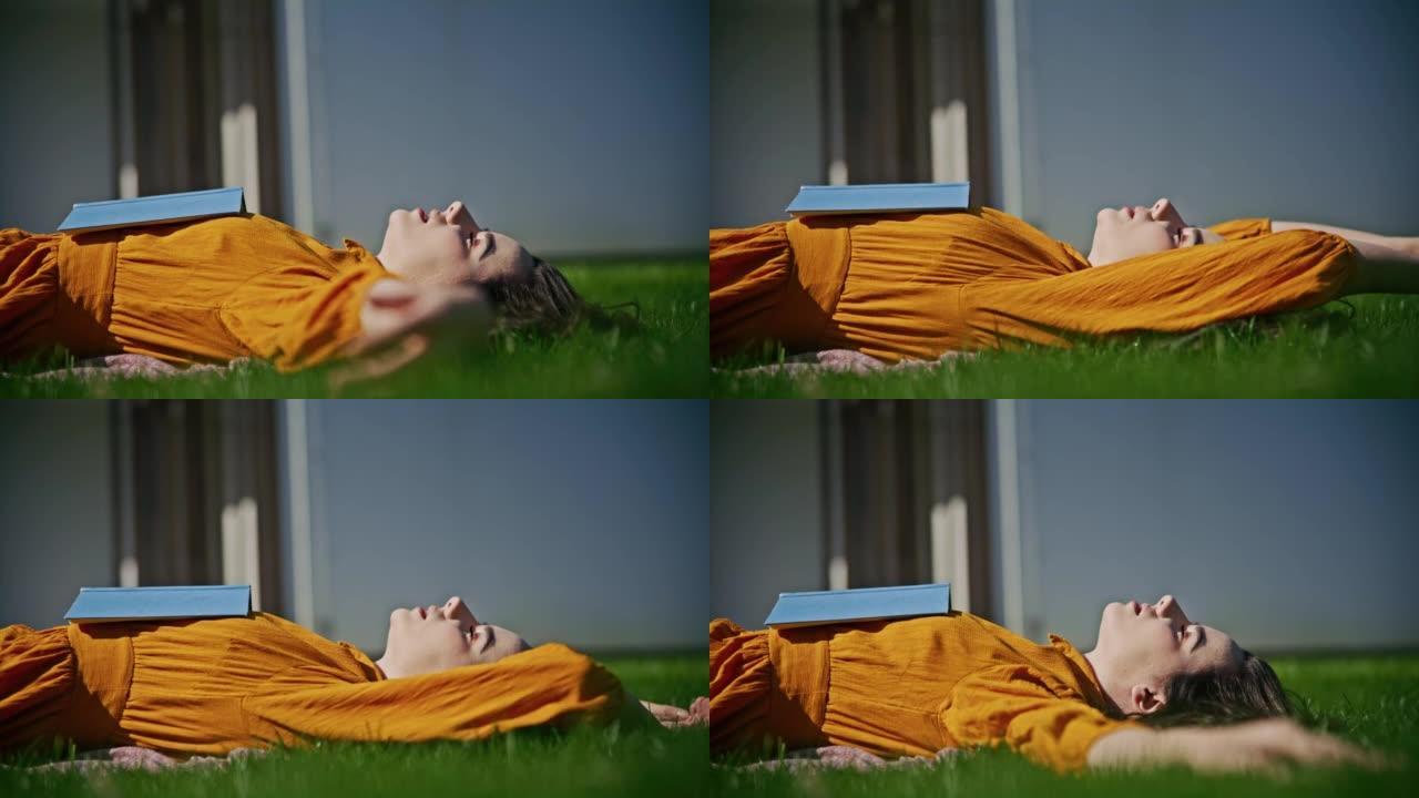 SLO MO年轻女子躺在草地上享受阳光