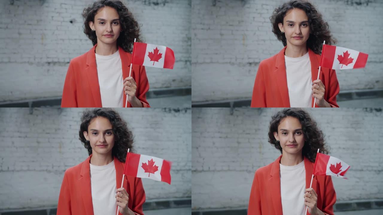 慢动作肖像，卷发妇女站在户外，加拿大国旗微笑