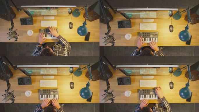 相机放大工作站上男性音乐家的俯视图，夜间在工作室中使用键盘和麦克风-慢动作拍摄
