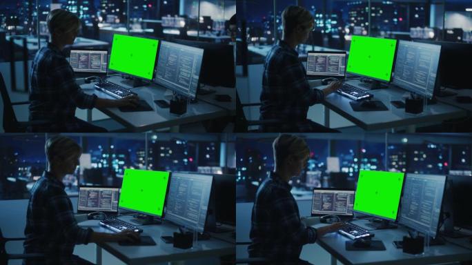 夜间办公室: 残疾人使用假肢在绿屏色度键计算机上工作。快速自然地使用肌电仿生手在夜间为软件键入代码。