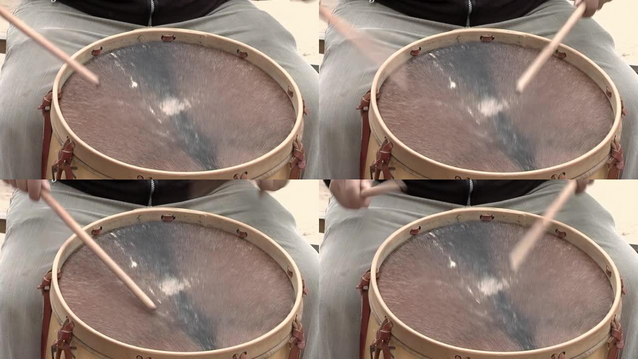 男子演奏 “Bombo Leguero”，这是一种用木头和动物皮革制成的阿根廷鼓，用于当地传统民俗音