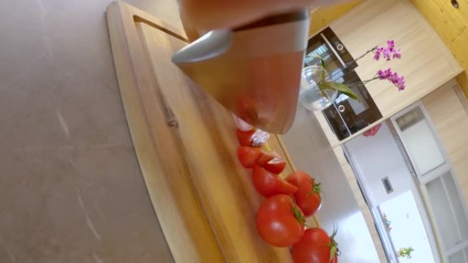 垂直: 锋利的厨师刀将美味的有机番茄切成小楔形。