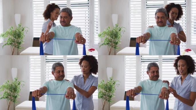 混合种族女理疗师使用锻炼带帮助老年人锻炼