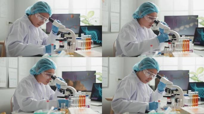 科学家在实验室用显微镜研究小细胞