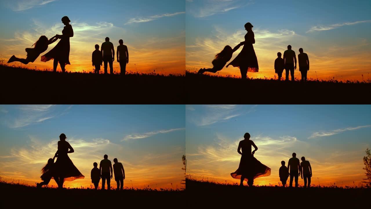 时间扭曲的母亲在黄昏时与两个儿子在草地上散步时旋转女儿