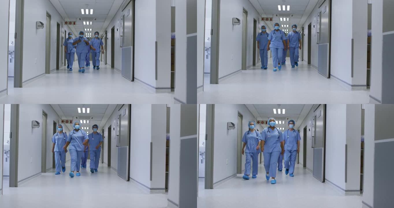 多元化女医生戴口罩走在医院走廊