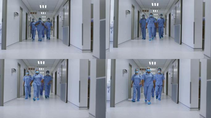多元化女医生戴口罩走在医院走廊