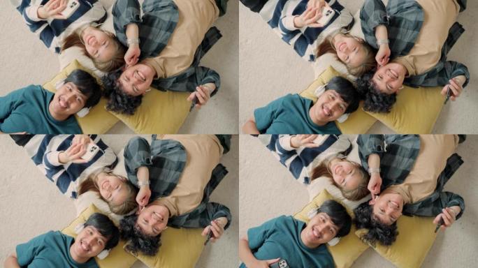 享受美妙的音乐。朋友聚会躺在地板上视频素