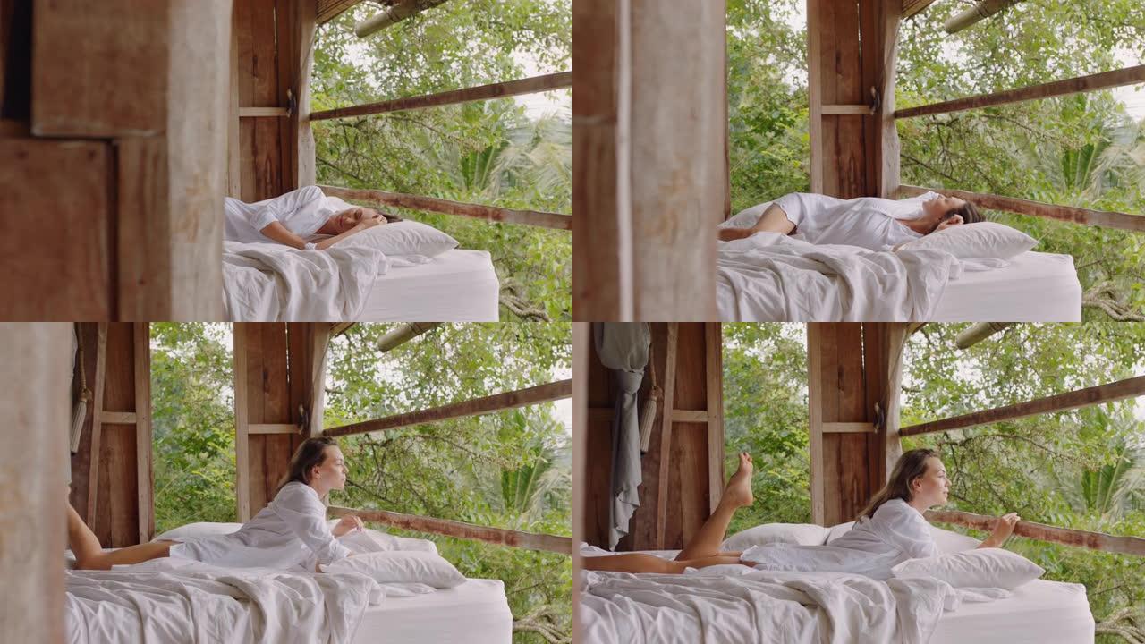 美丽的女人在酒店度假村的床上醒来，享受天堂4k的假期