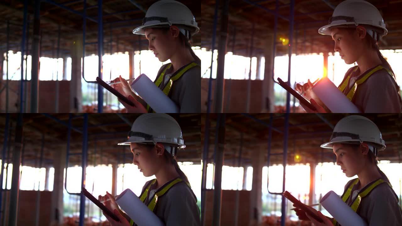 女建筑师在建筑工地手持平板电脑